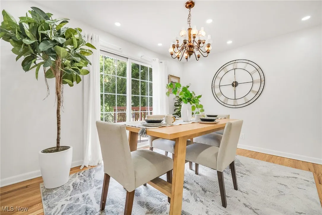 Dining area with a chandelier, recessed lighting, baseboards, and wood finished floors