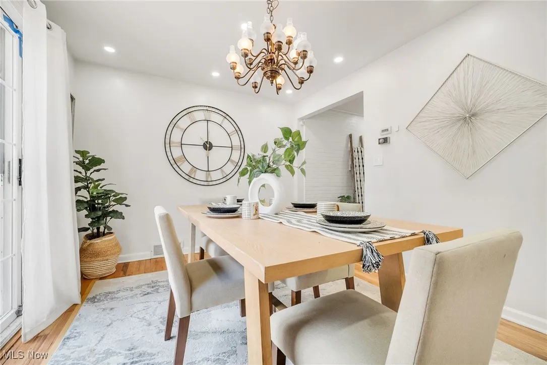Dining room with a chandelier, light wood-style flooring, recessed lighting, and baseboards