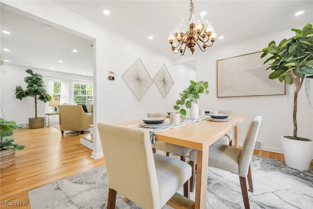 Dining area featuring recessed lighting, light wood-style flooring, a chandelier, and baseboards