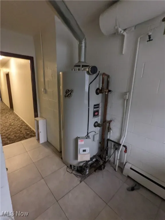 Utilities featuring water heater and a baseboard radiator