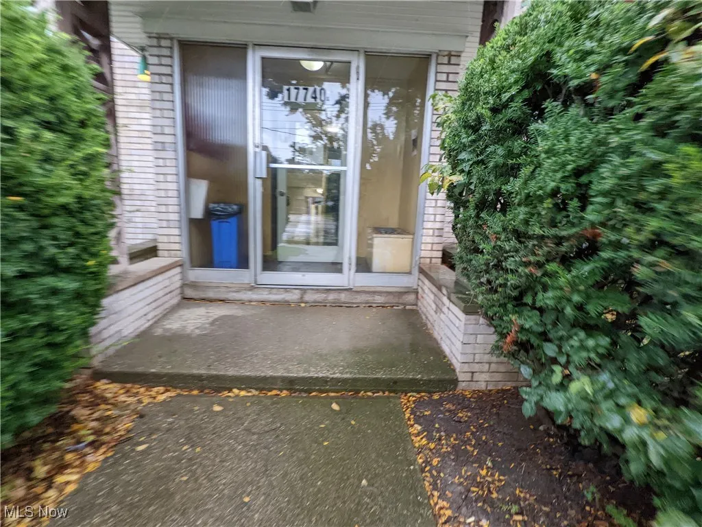View of exterior entry with brick siding