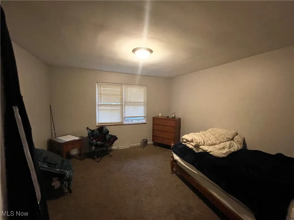 Carpeted bedroom with baseboards