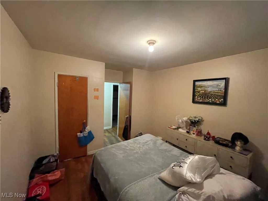 Bedroom with dark wood-style flooring
