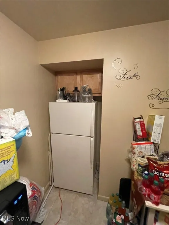 Kitchen with refrigerator and baseboards