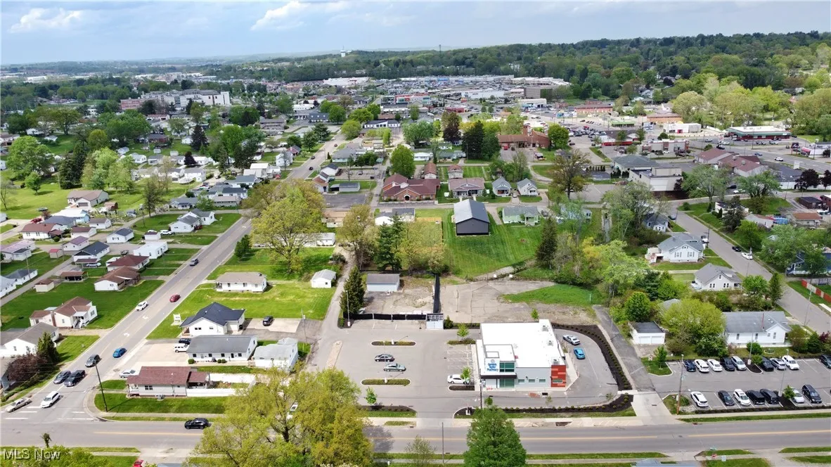 Aerial view of property's location with nearby suburban area