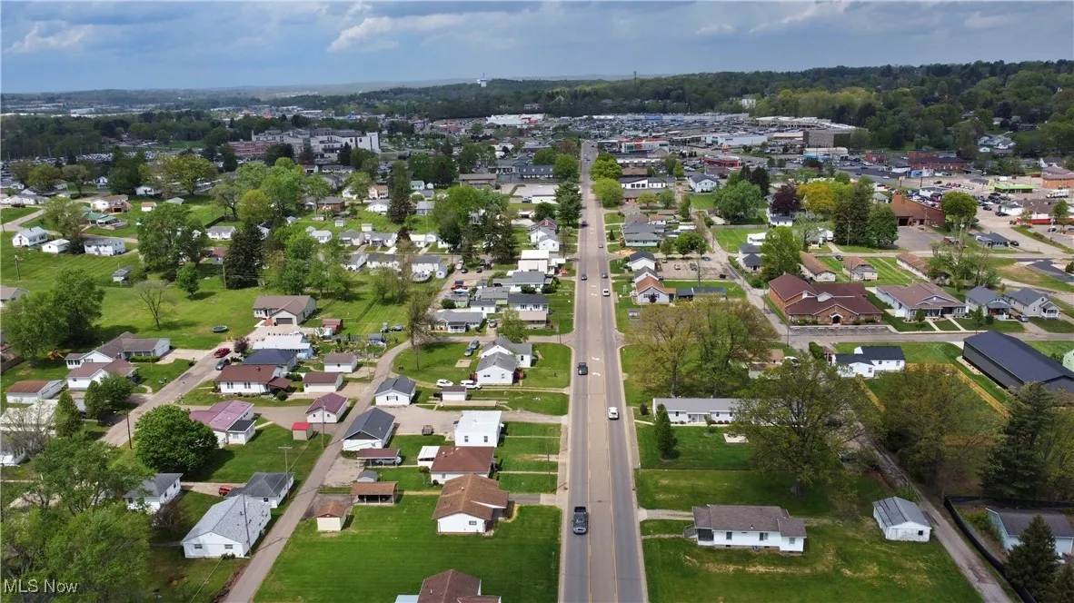 Aerial view of property's location featuring nearby suburban area