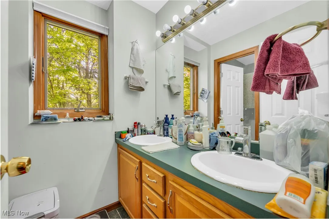 Main bath with double sinks and separate shower/tub area
