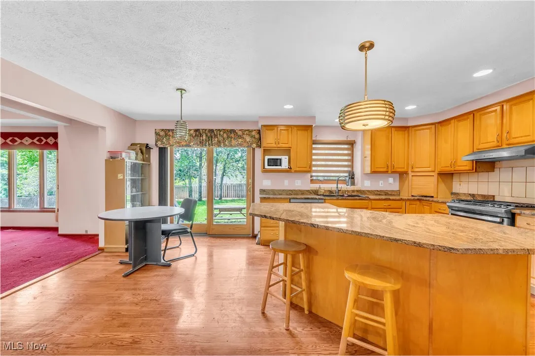 Dream Eat-in Kitchen with recessed lighting, hardwood floors and beautiful view of Private backyard
