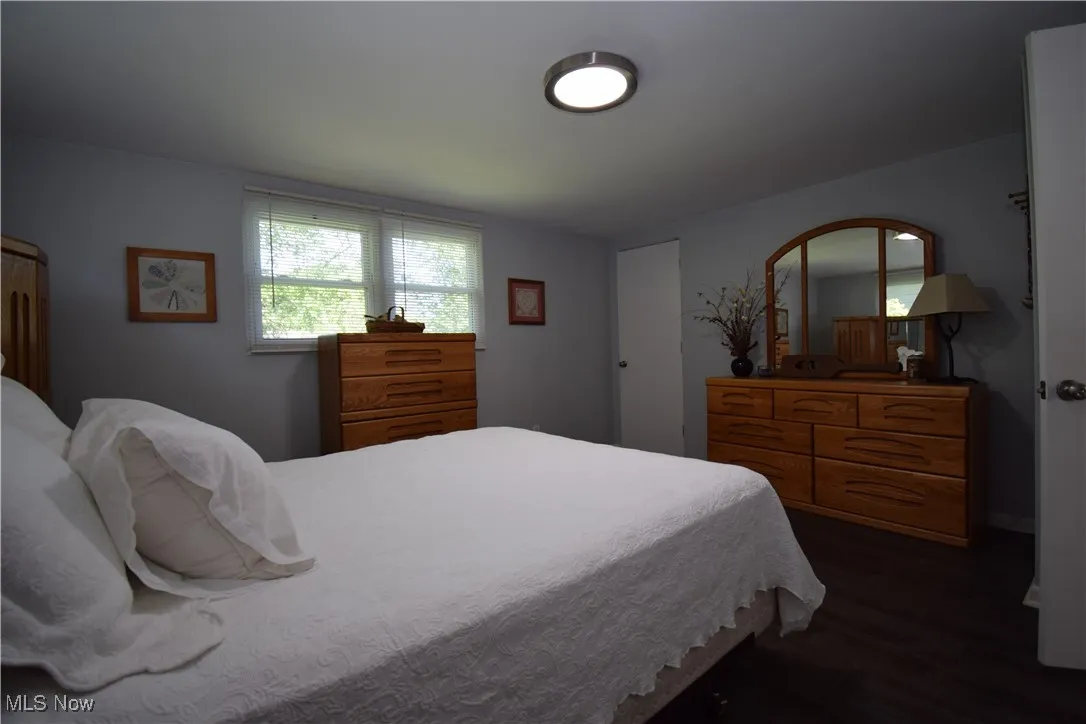Bedroom with dark wood-style floors