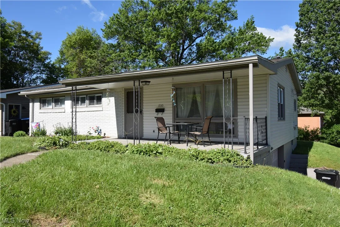 View of front of house featuring a front yard and brick siding
