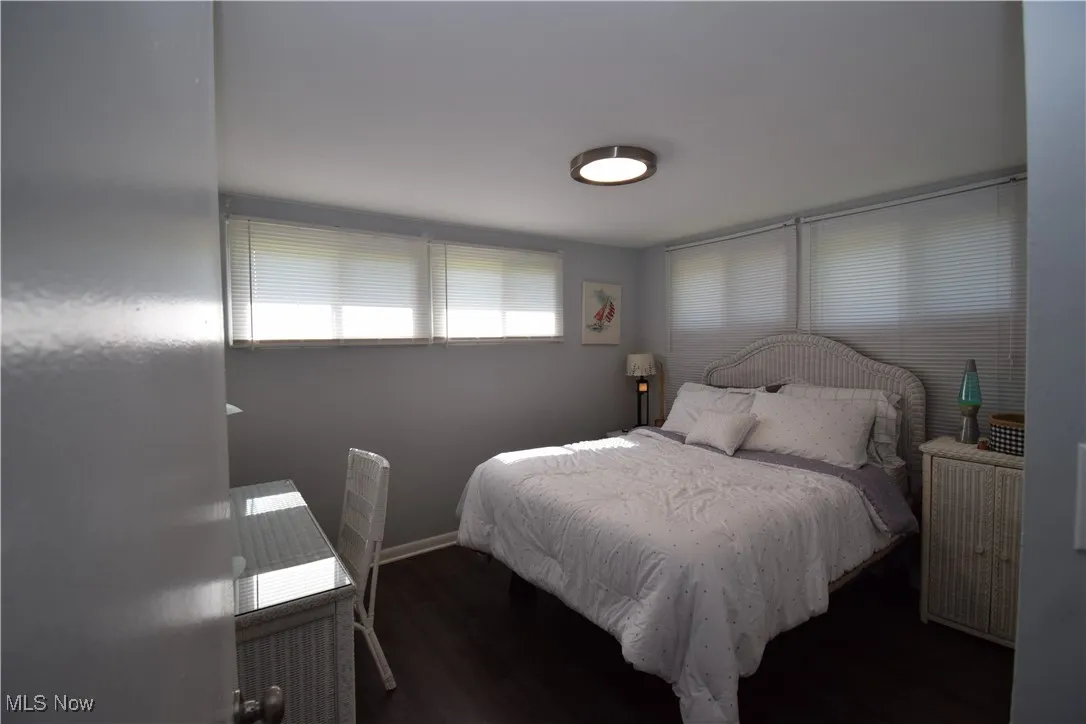 Bedroom featuring wood finished floors and baseboards