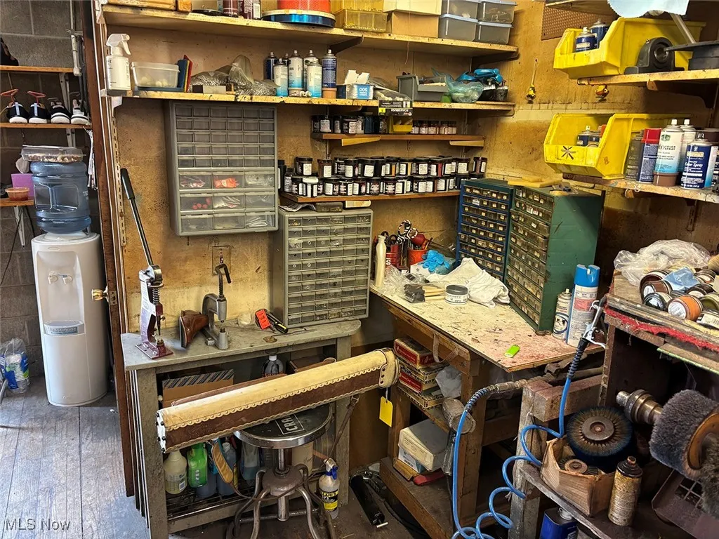 Misc room featuring a workshop area and wood-type flooring