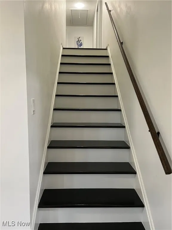 Staircase featuring attic access
