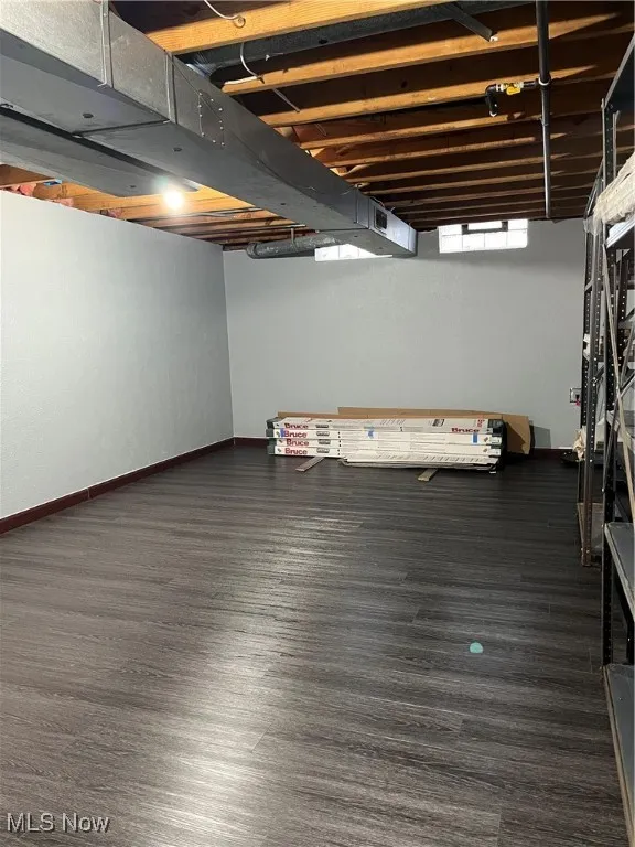 Below grade area with baseboards and wood finished floors