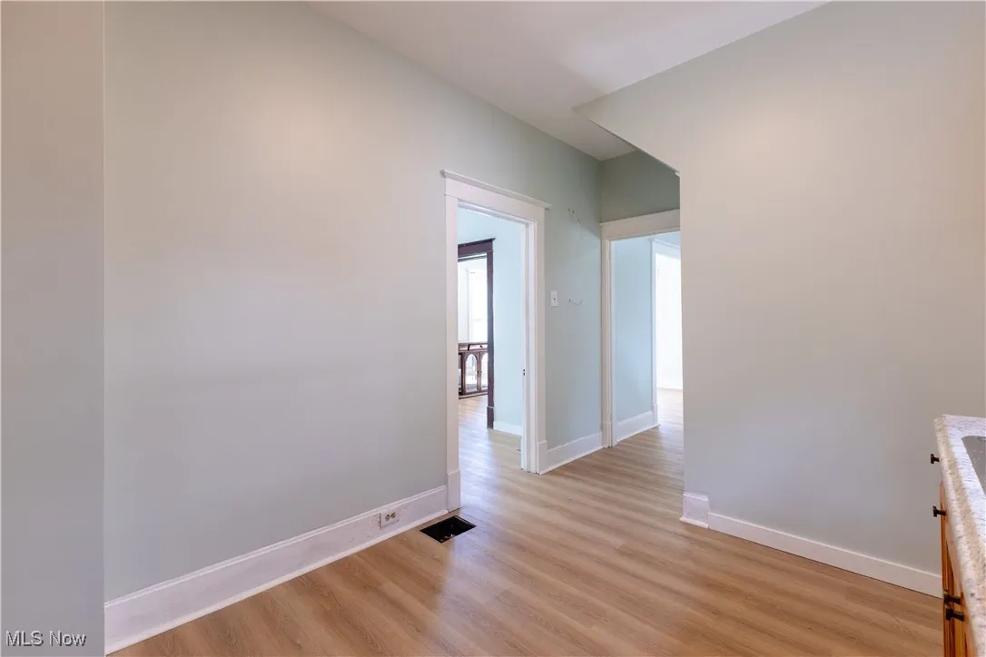 Hall featuring light wood-type flooring and baseboards