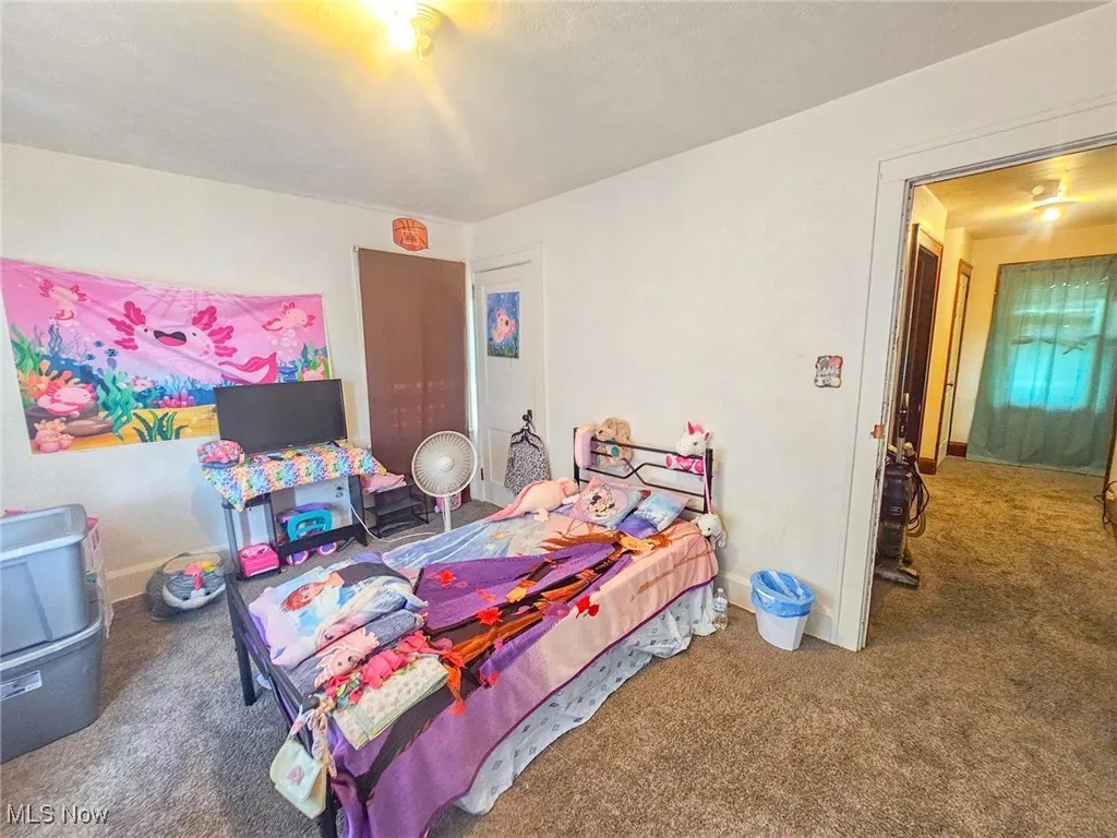 Carpeted bedroom with baseboards