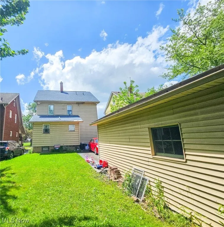 Back of house featuring a yard