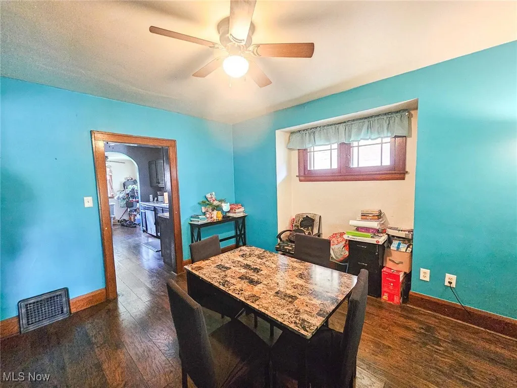 Dining room featuring ceiling fan, wood-type flooring, and baseboards