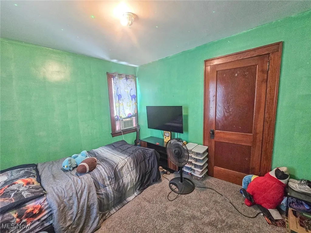 Bedroom with carpet floors and cooling unit