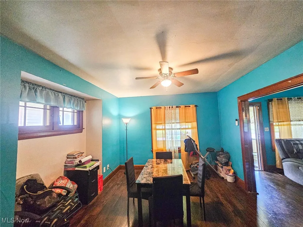 Dining space with hardwood / wood-style floors, ceiling fan, and baseboards