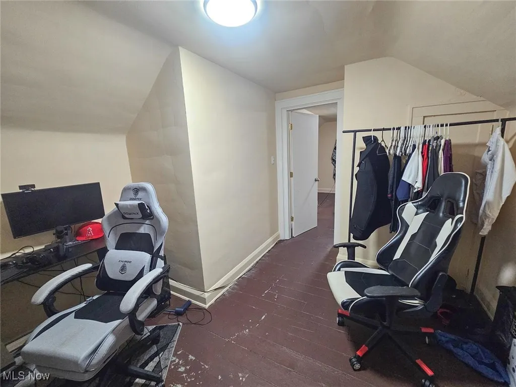 Office with vaulted ceiling, hardwood / wood-style floors, and baseboards