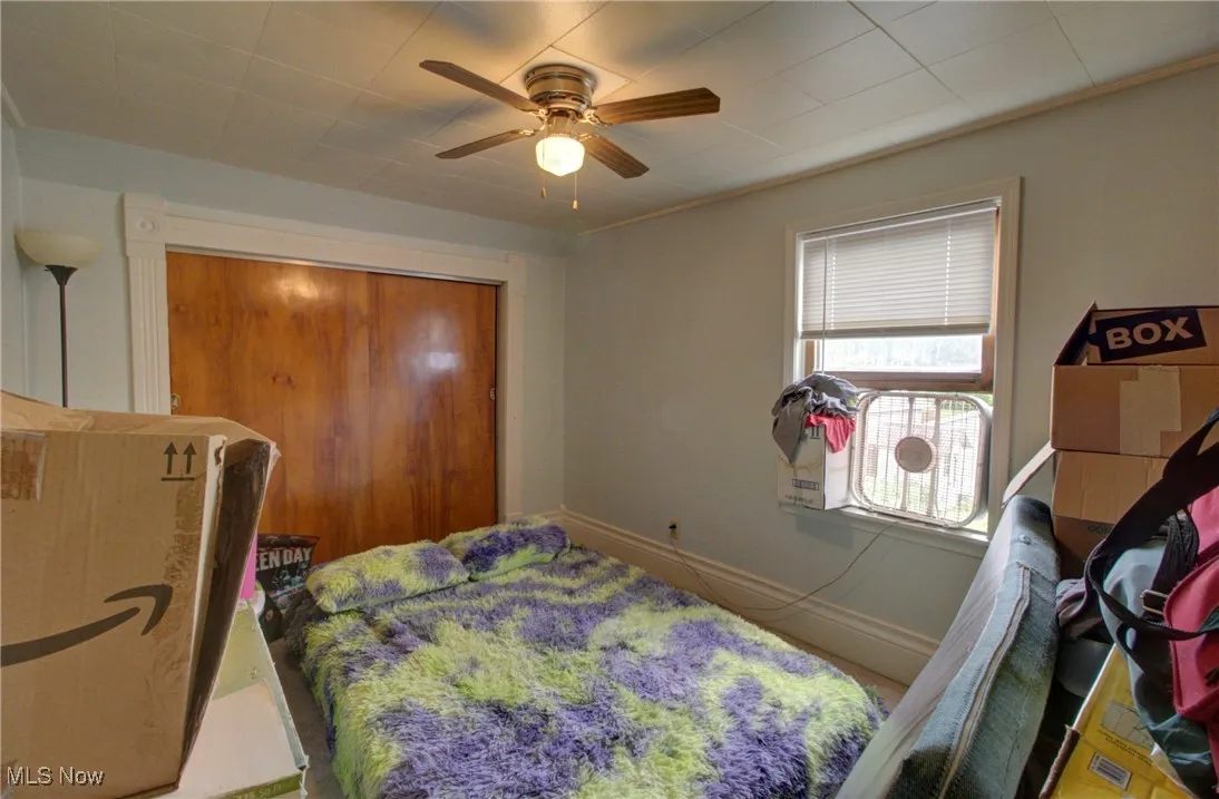 Bedroom featuring ceiling fan and baseboards