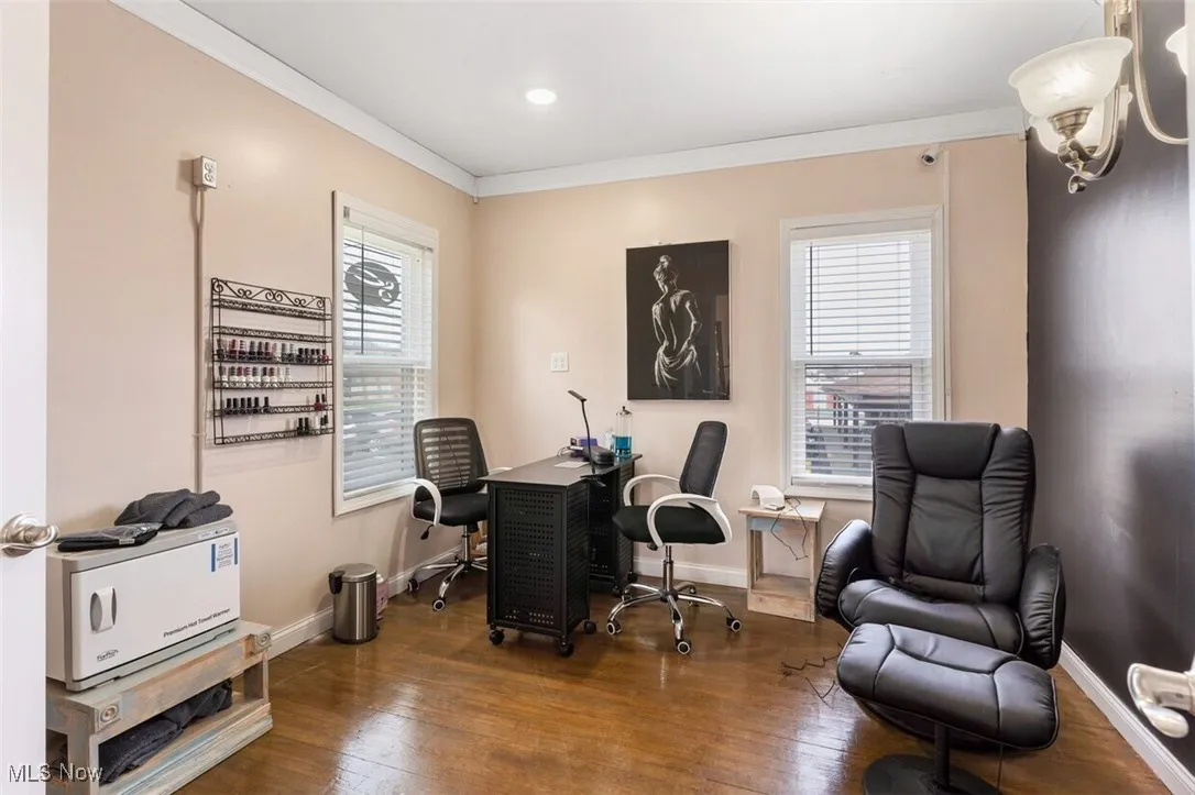 Home office featuring crown molding, hardwood / wood-style flooring, and baseboards