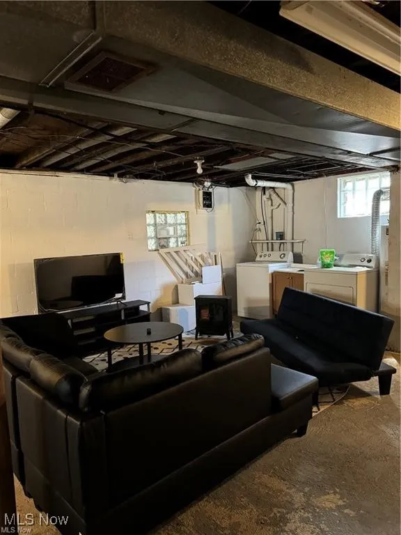 Living room with washing machine and clothes dryer