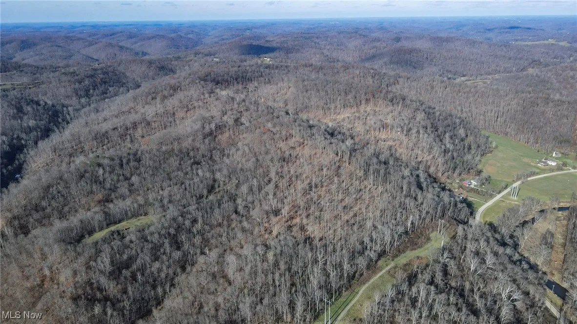 View of property location featuring a forest