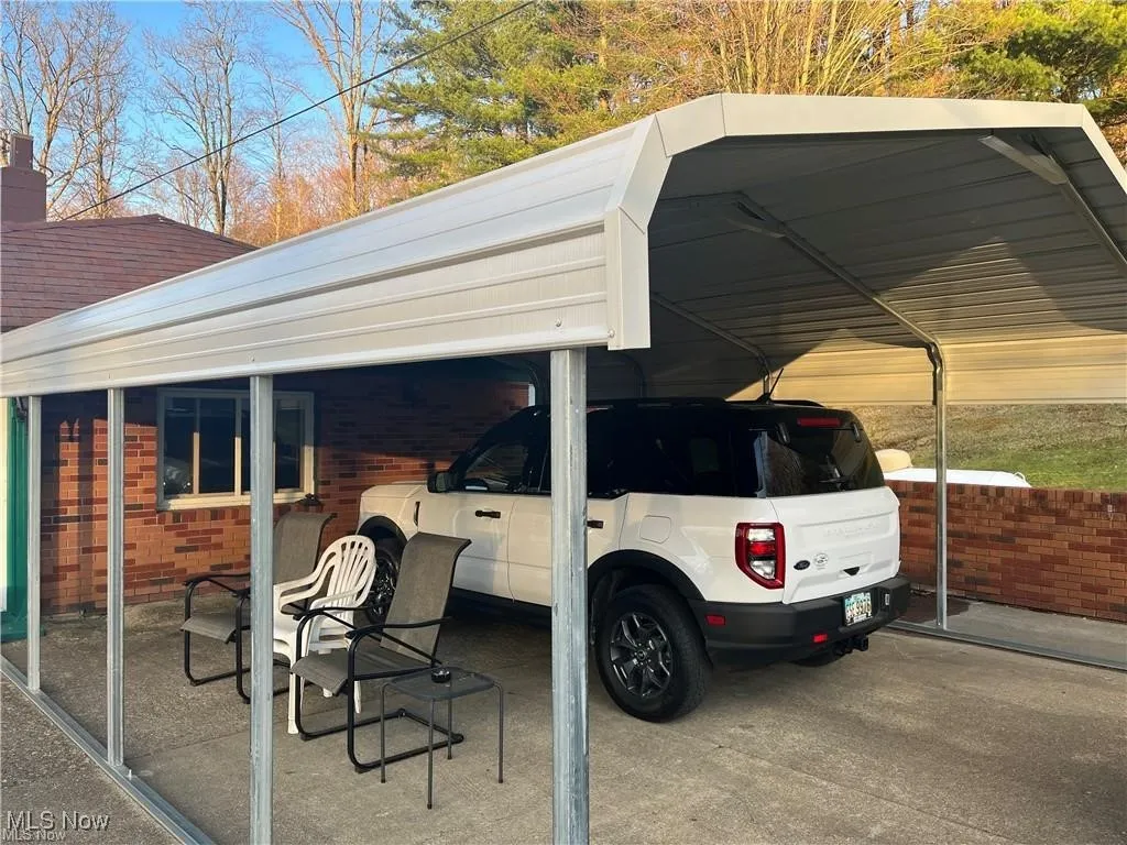 View of vehicle parking featuring a detached carport