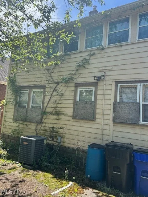 View of side of home featuring central AC