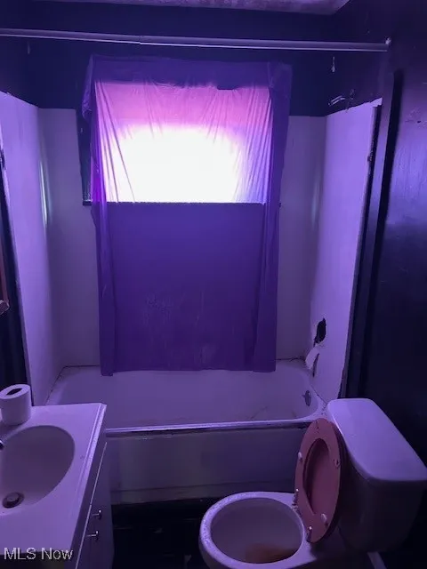 Bathroom with toilet, shower / washtub combination, and vanity