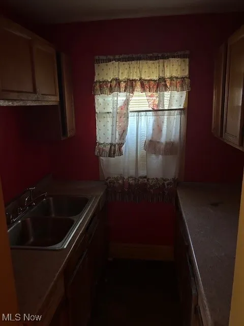 Kitchen featuring a sink and light countertops