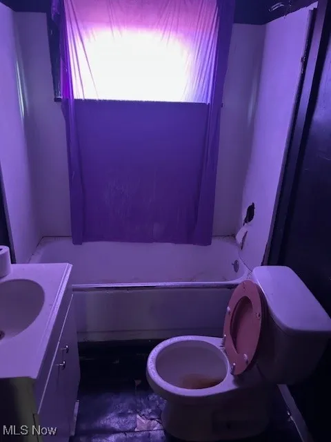 Full bath featuring toilet,  shower combination, vanity, and plenty of natural light
