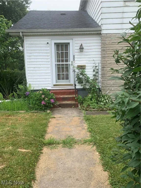 Property entrance with a shingled roof