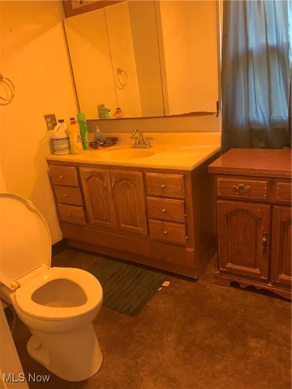 Bathroom featuring vanity and toilet