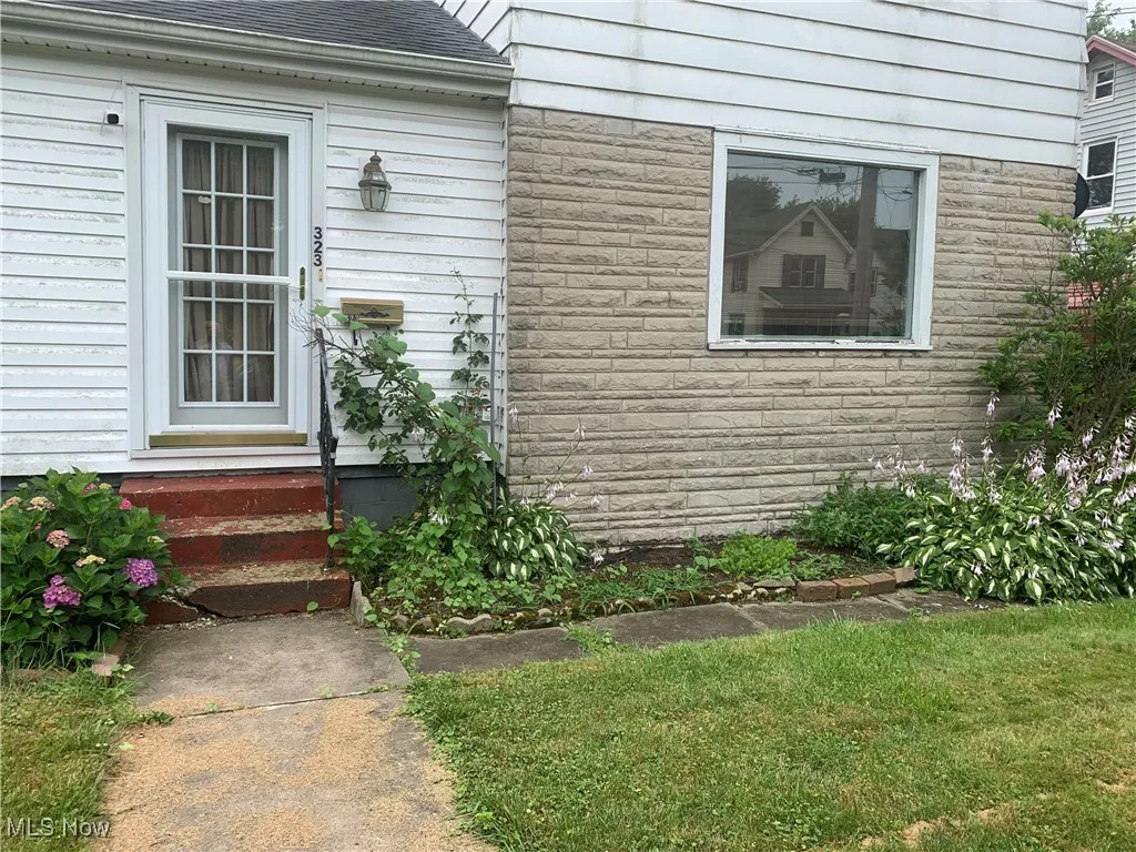 Property entrance featuring roof with shingles