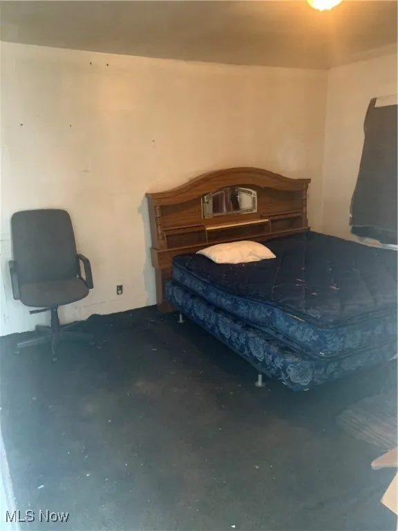 Bedroom featuring concrete flooring