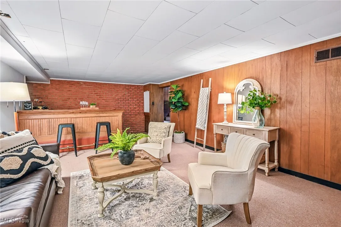 Family room showing Brick and paneled wall and bar