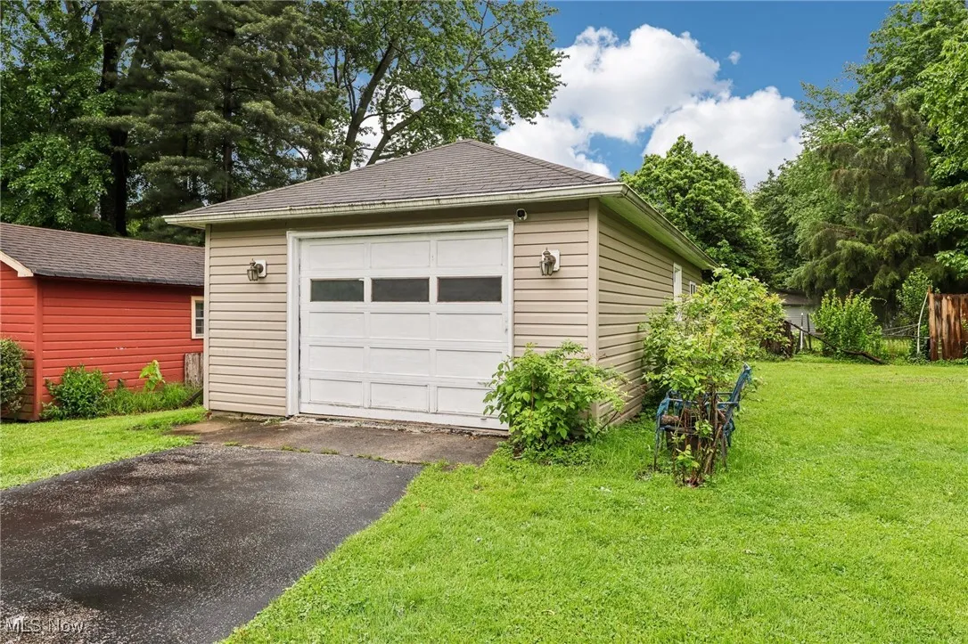 Detached garage with asphalt driveway