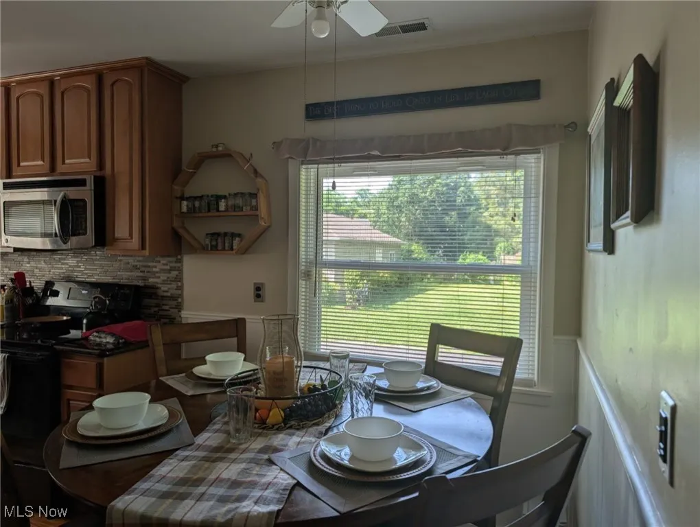 Dining space featuring healthy amount of natural light and ceiling fan