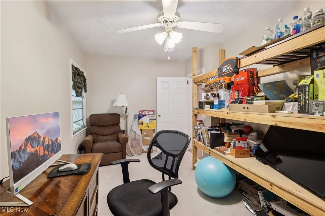Office area featuring a ceiling fan