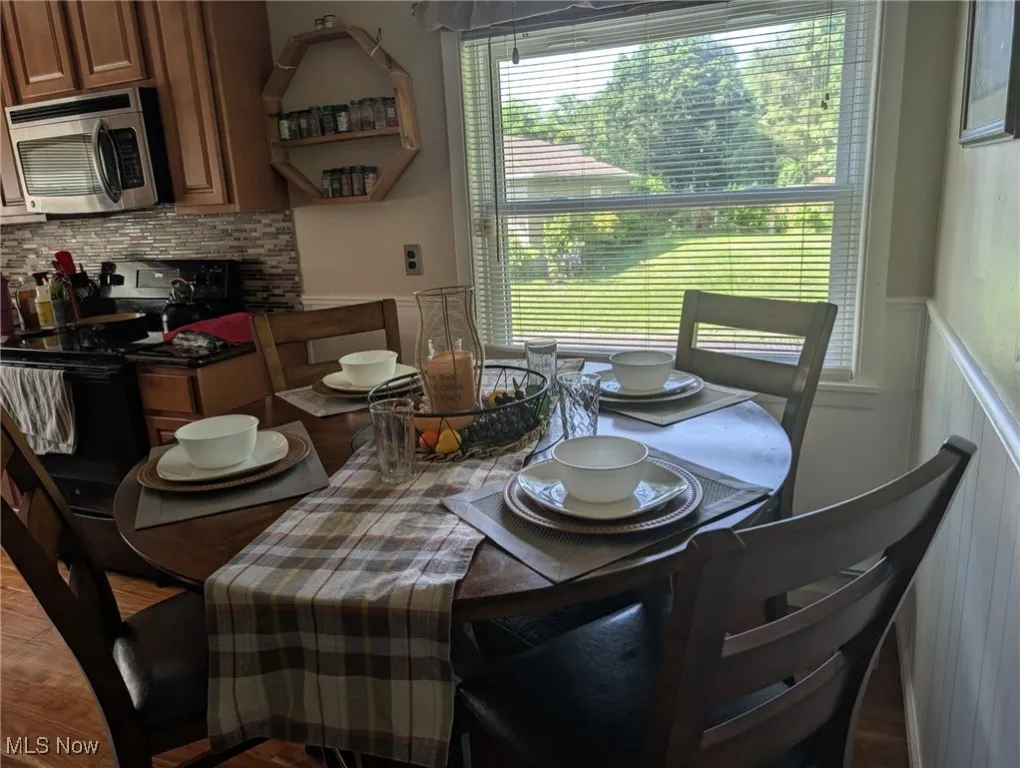 Dining area featuring wainscoting