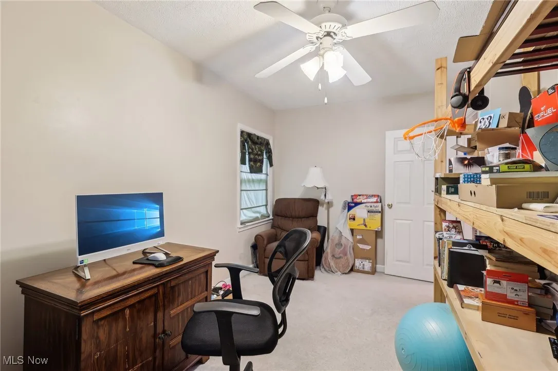 Carpeted office with ceiling fan