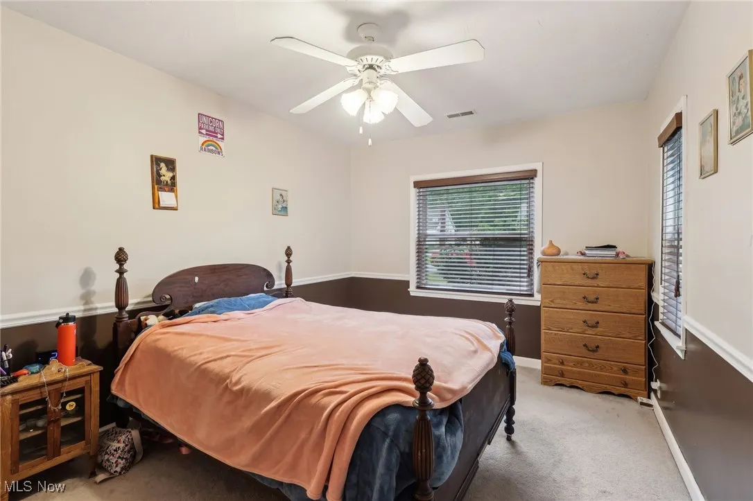 Bedroom with carpet, baseboards, and ceiling fan