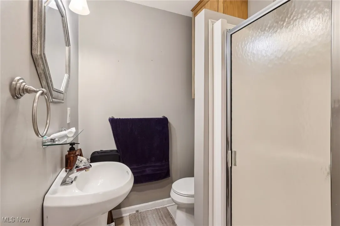 Full bathroom with a shower stall and toilet