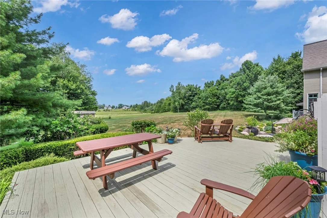 Wooden deck featuring view of scattered trees
