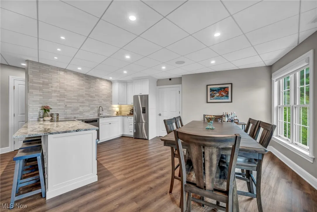Dining room featuring dark wood-style flooring and recessed lighting