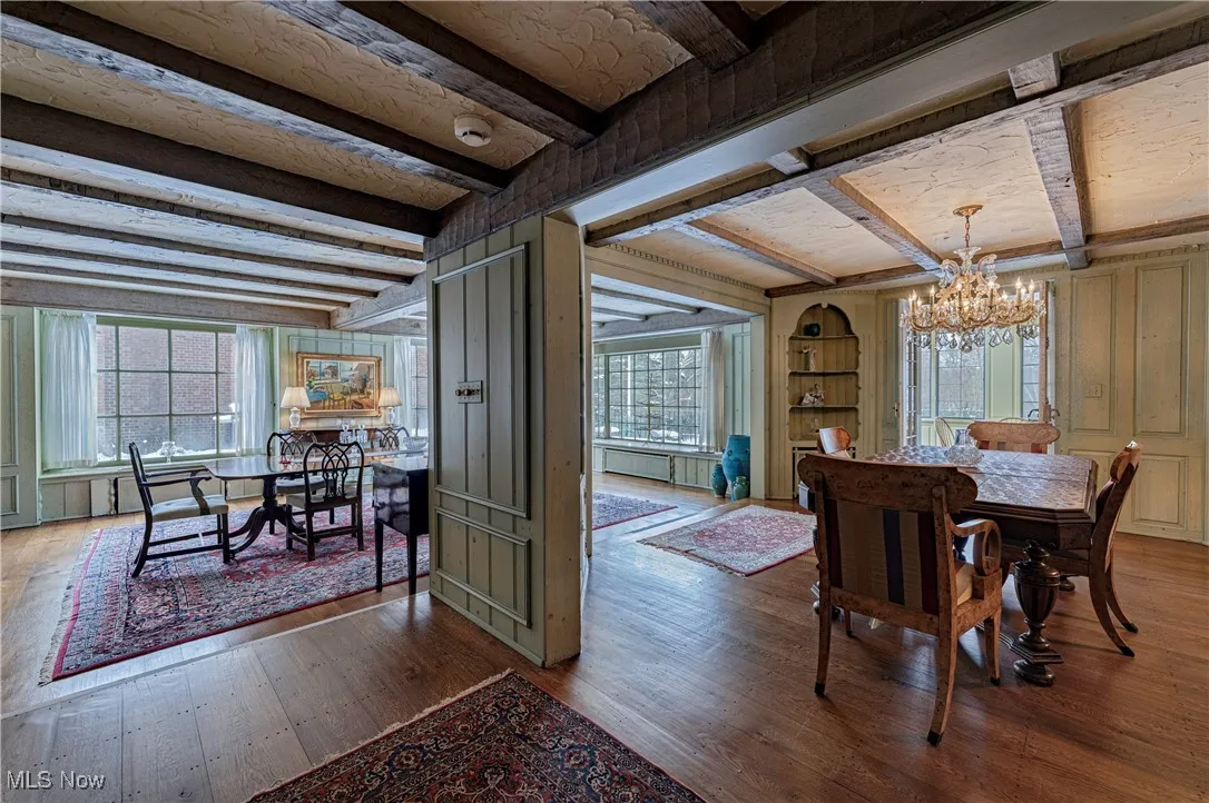 Dining area featuring a chandelier, beam ceiling, and hardwood / wood-style floors