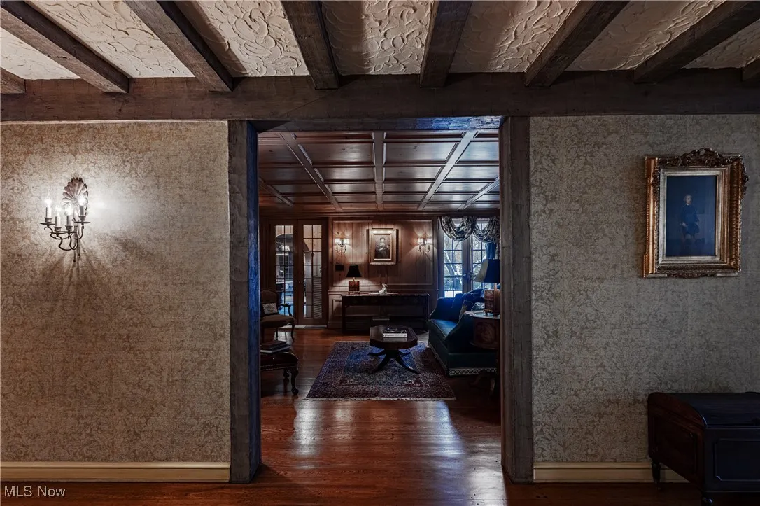 Hall with dark hardwood / wood-style floors and beam ceiling